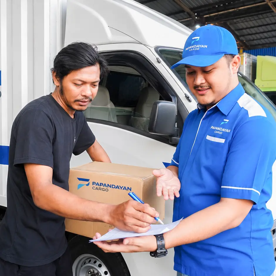 Pengiriman barang pindahan dengan serah terima barang antara customer dan petugas Papandayan Cargo di samping armada pengiriman.